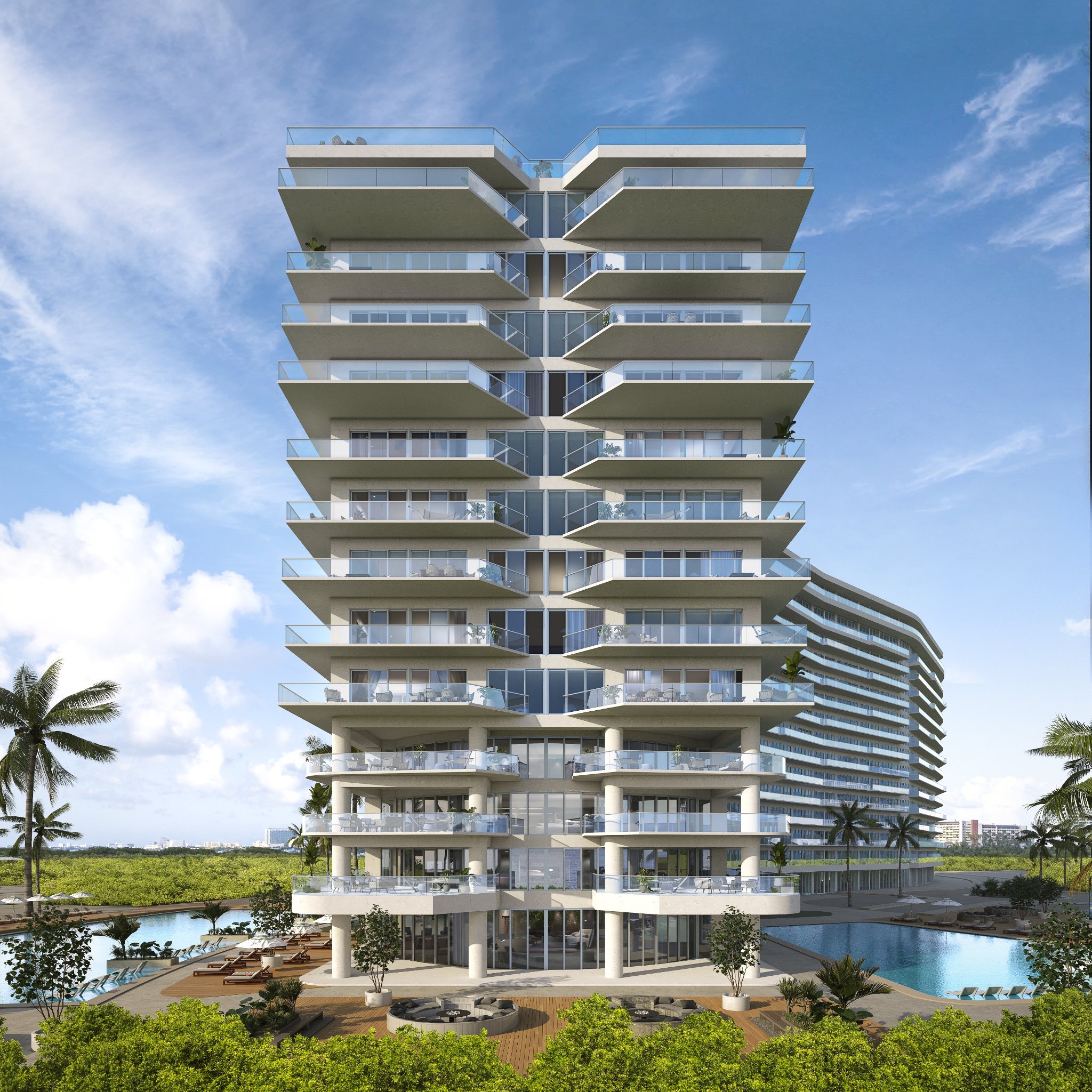 A tall modern residential building with multiple balconies, surrounded by palm trees, a swimming pool, and lush greenery, under a blue sky with scattered clouds.