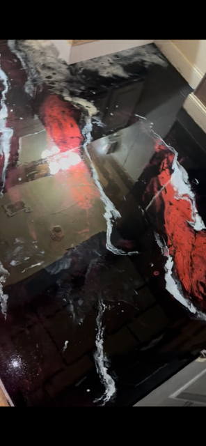 Custom black, white, and red metallic epoxy floor with lava-effect veining by Tru Epoxy Nation Atlanta.