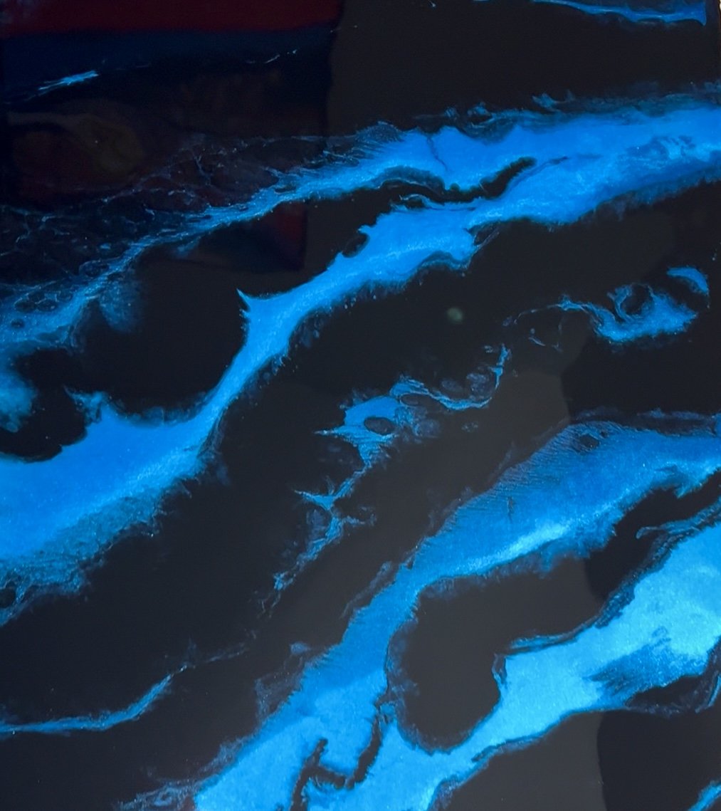 Custom electric blue metallic epoxy floor with black base and glowing river-effect veining by Tru Epoxy Nation Atlanta.