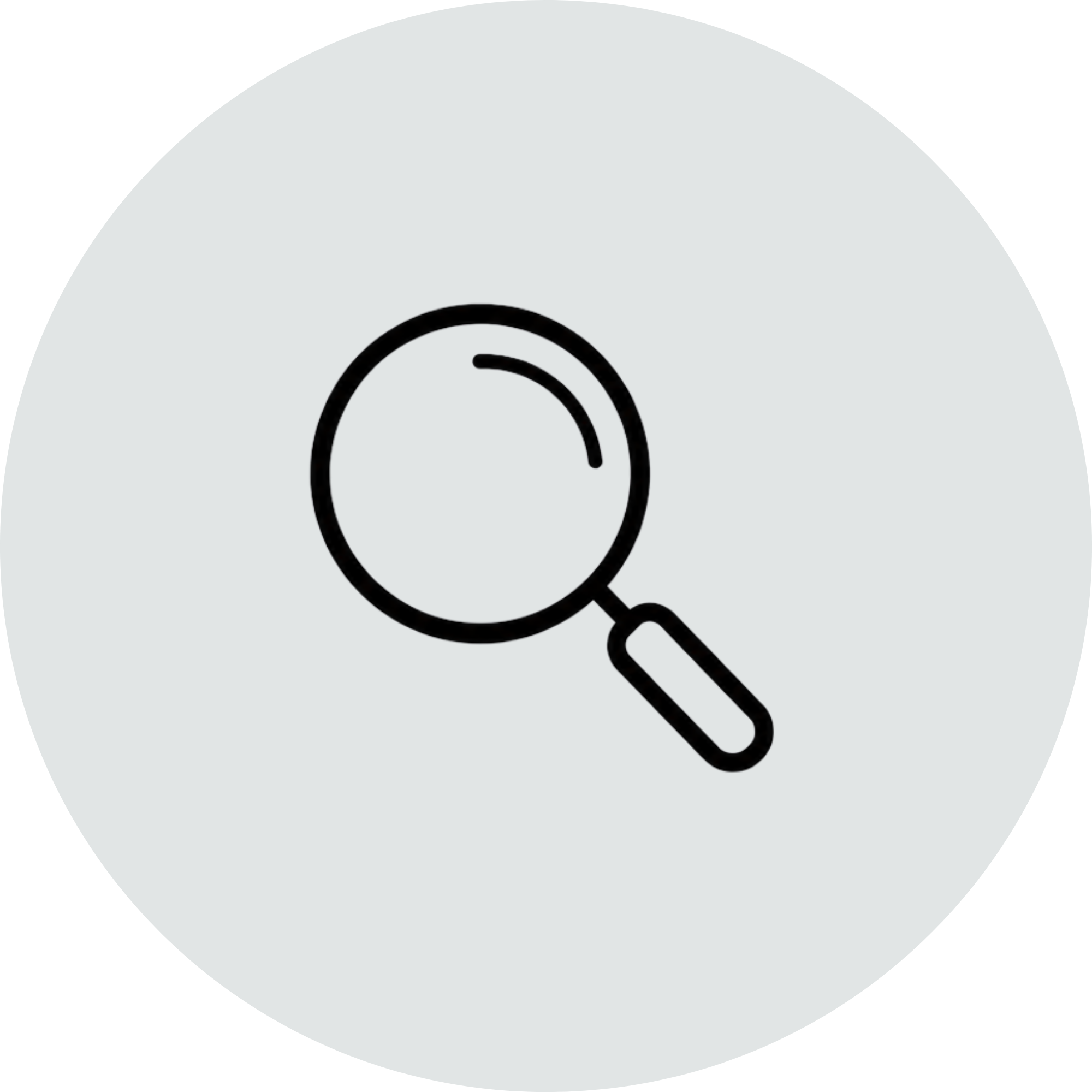 Close-up of a magnifying glass over a gray surface with a circular black outline.