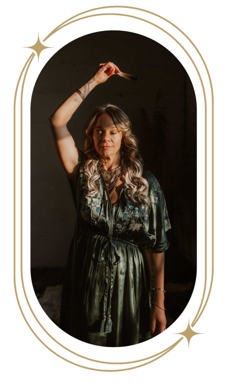 A woman with long, wavy blonde hair waving her hand with a strand of hair, standing in front of a dark background, framed by a decorative gold border.