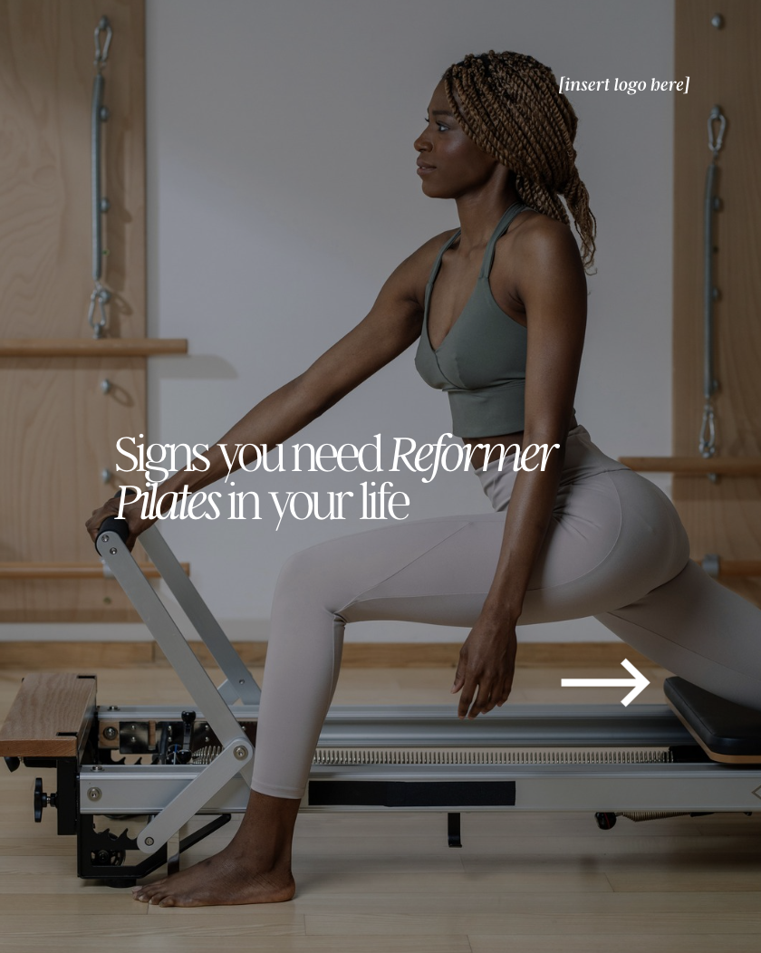 A woman in athletic clothing is sitting on a Pilates reformer in a fitness studio, performing an exercise.