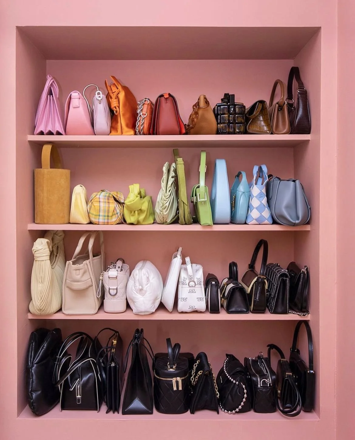 a pink bookshelf full of purses