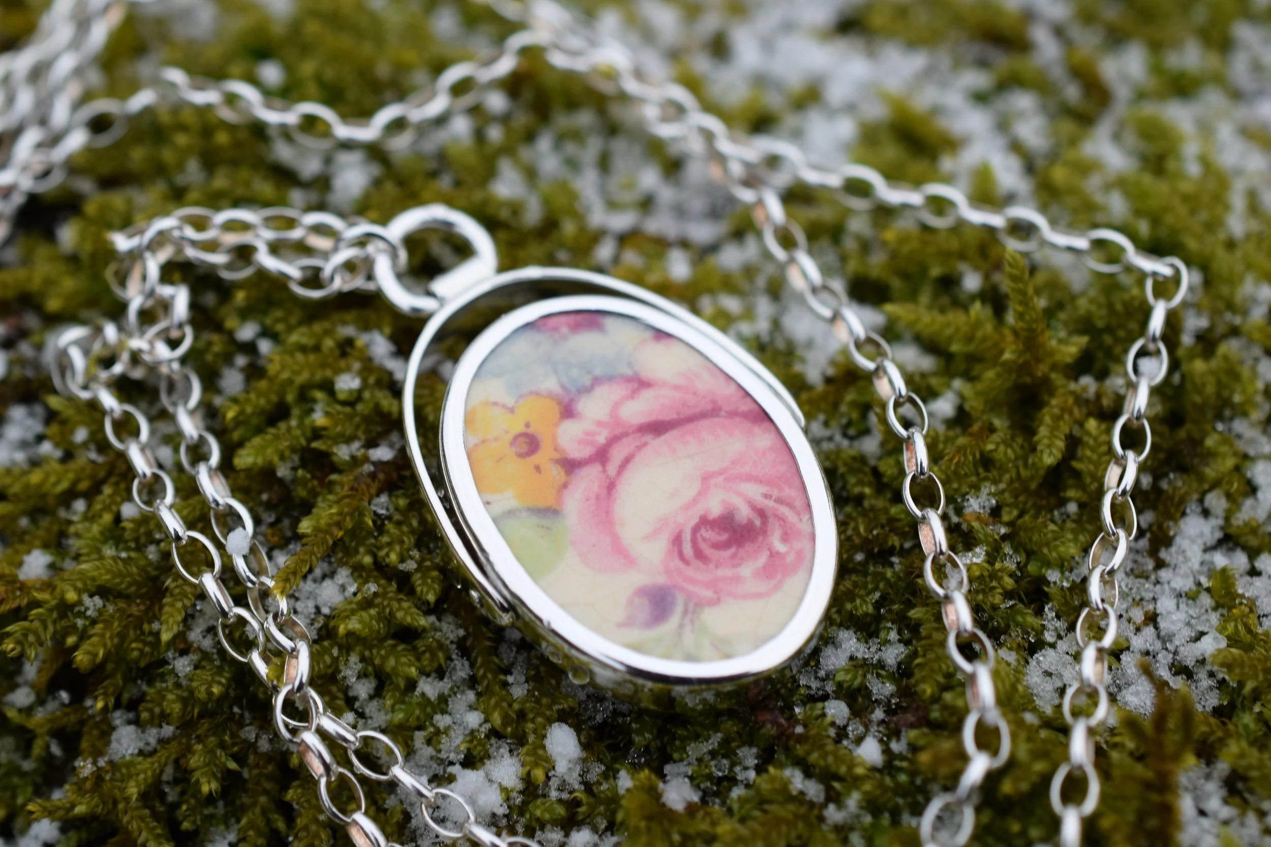 Silver spinner necklace made with a sherd of found pottery.