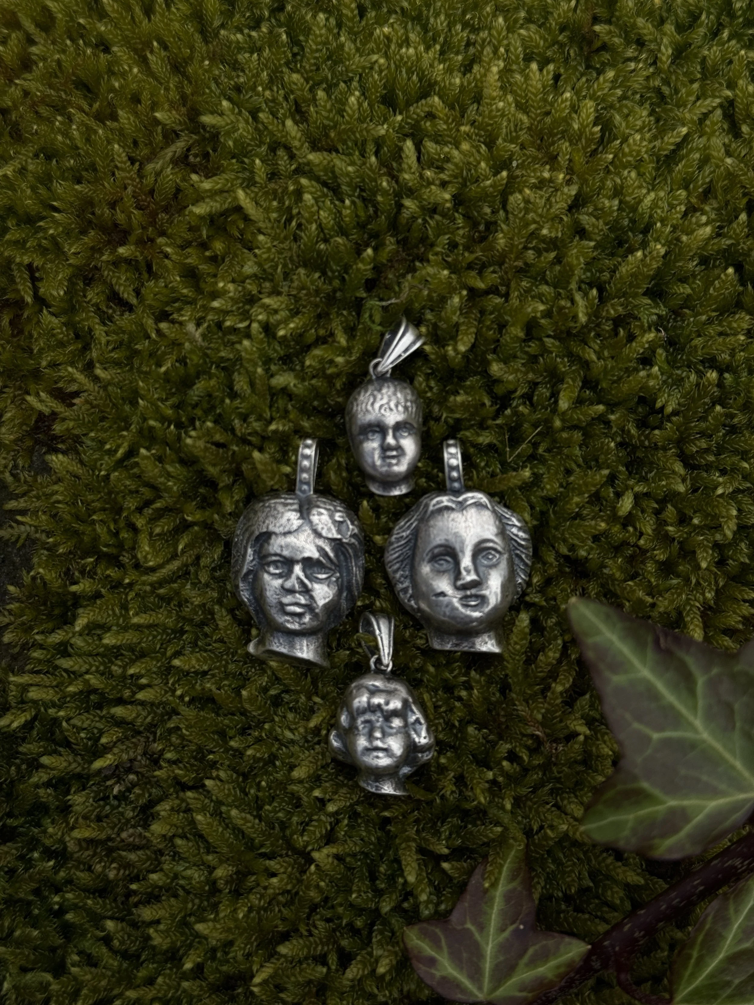 Silver doll head pendants cast from our finds 2026