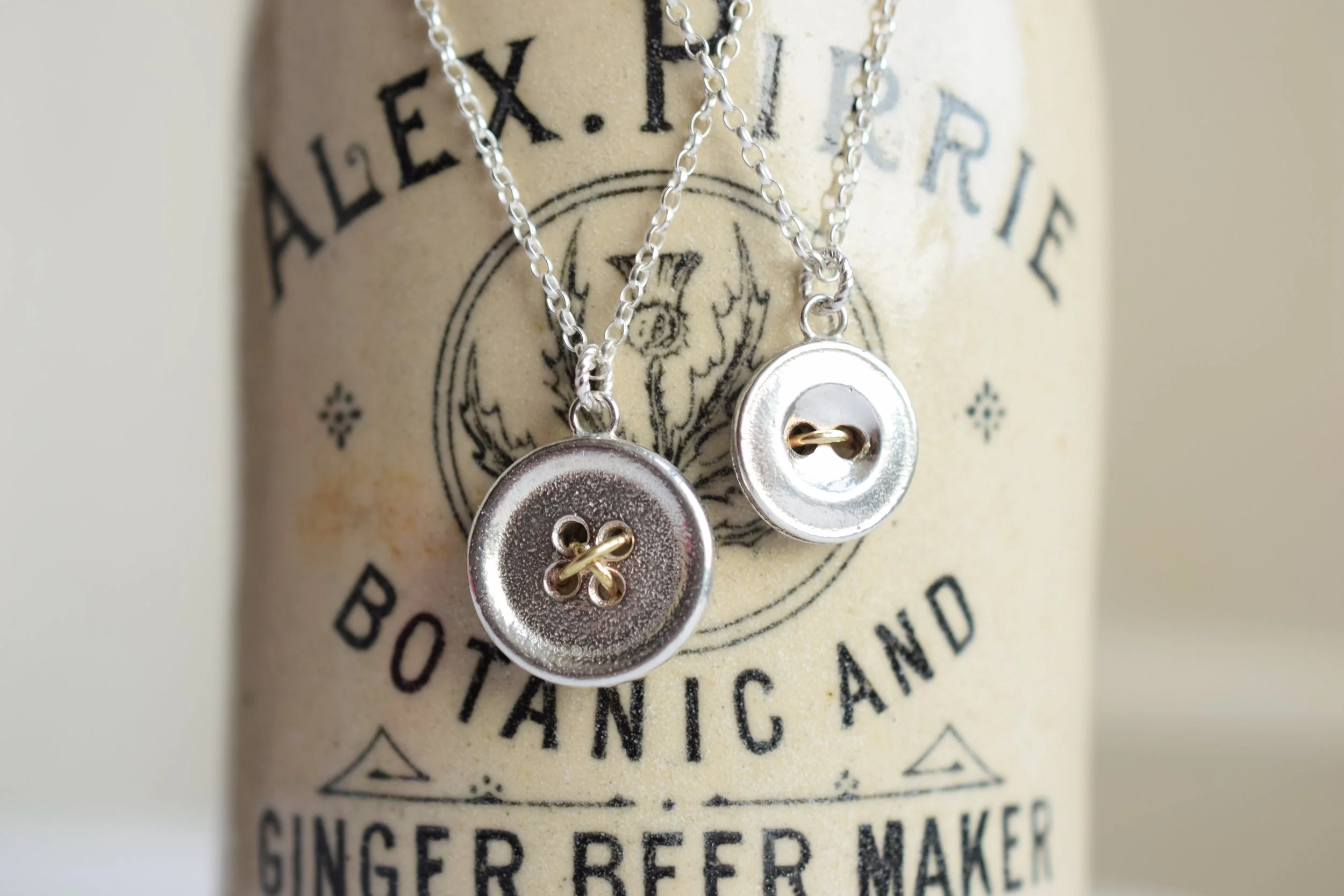 Button necklaces made with brass wire 'thread'. Cast from some of our found buttons. 