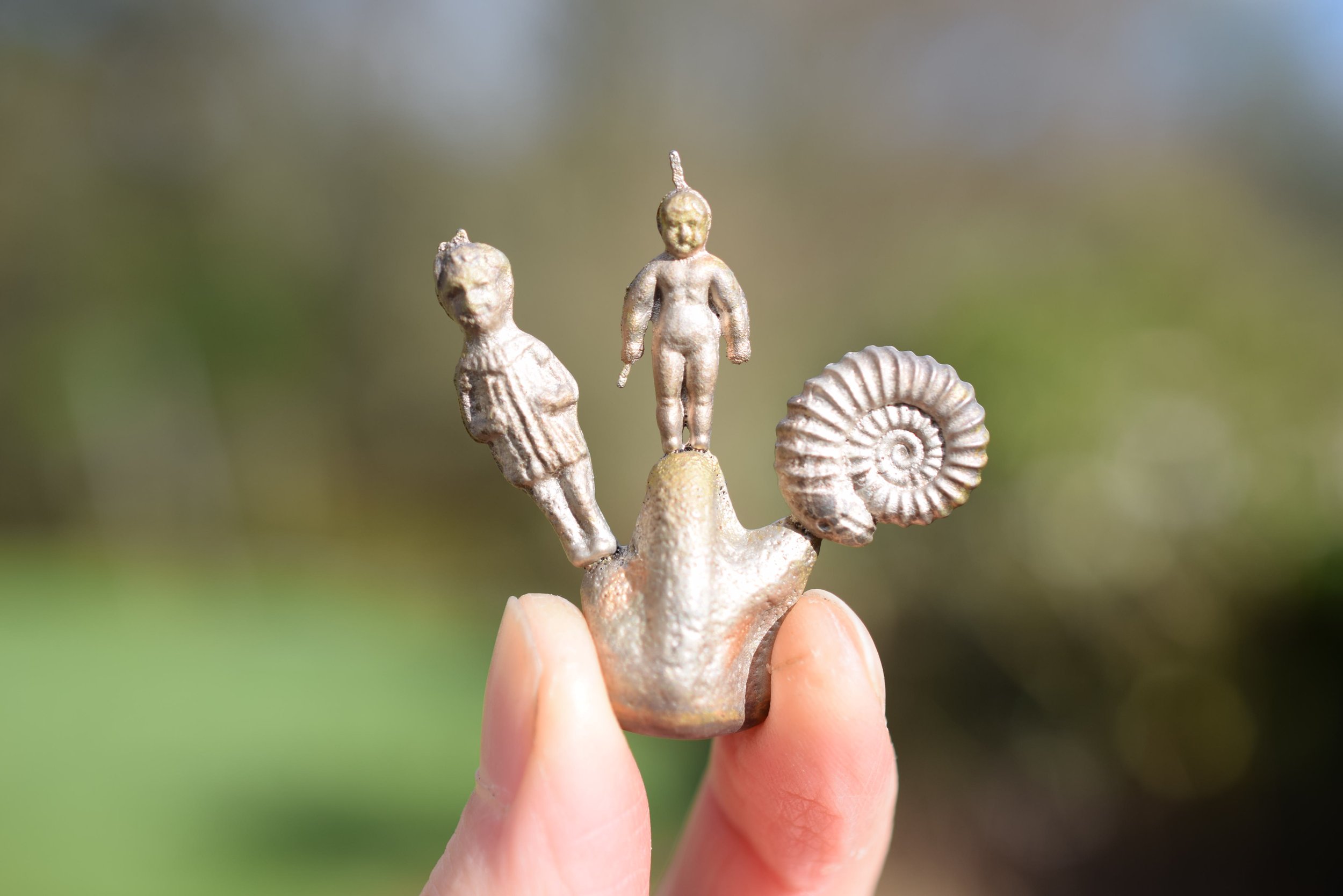 Sand cast items attached to their sprue. 