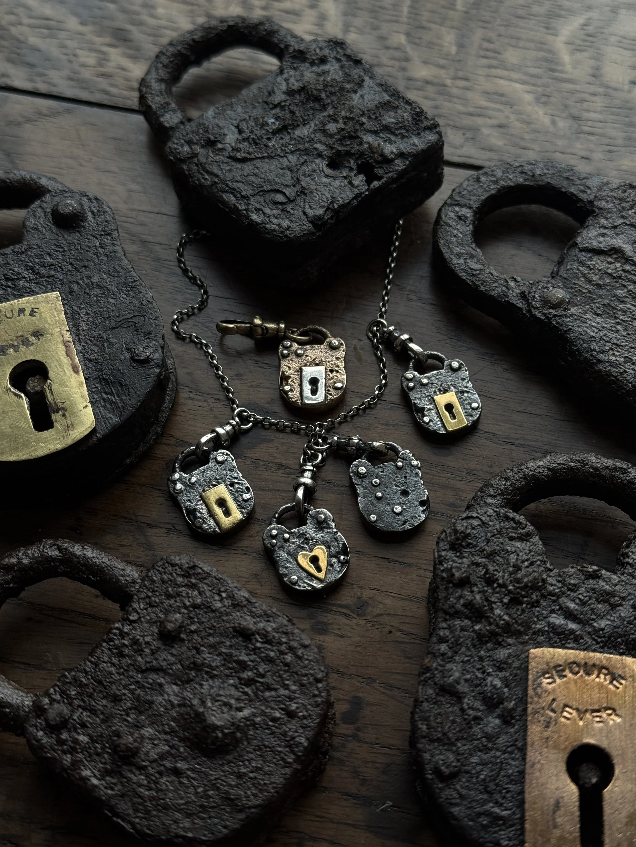 Silver padlock charms, inspired by the rusty Victorian/ Edwardian iron and brass padlocks we find during our larks. 