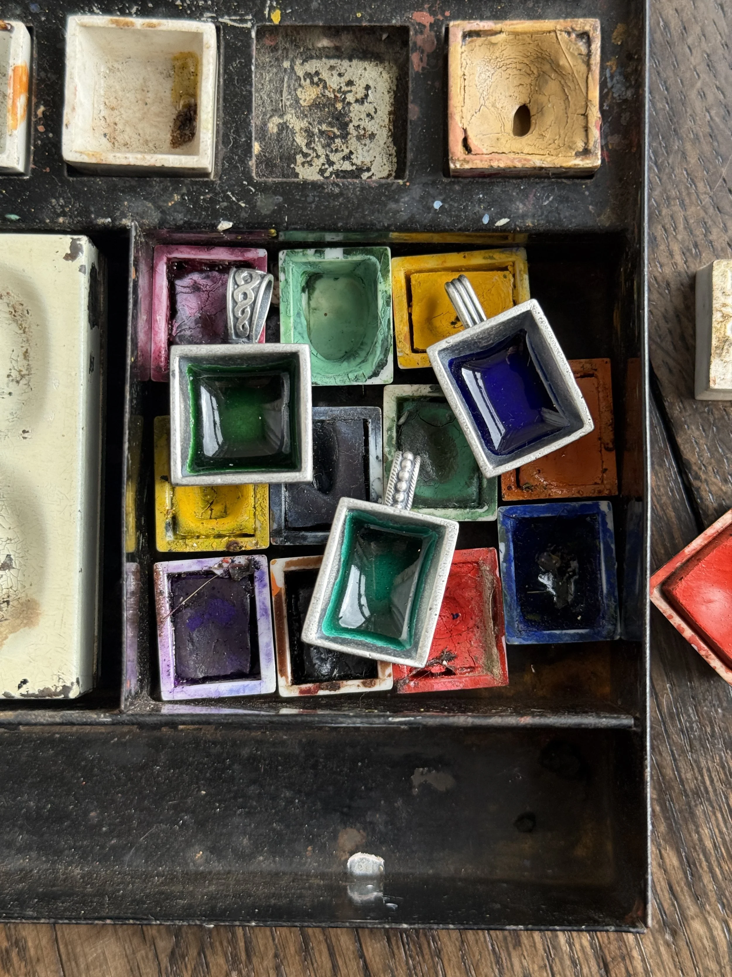 Silver and enamel paint pan necklaces, cast from the antique porcelain paint pans we find on our larks 2026