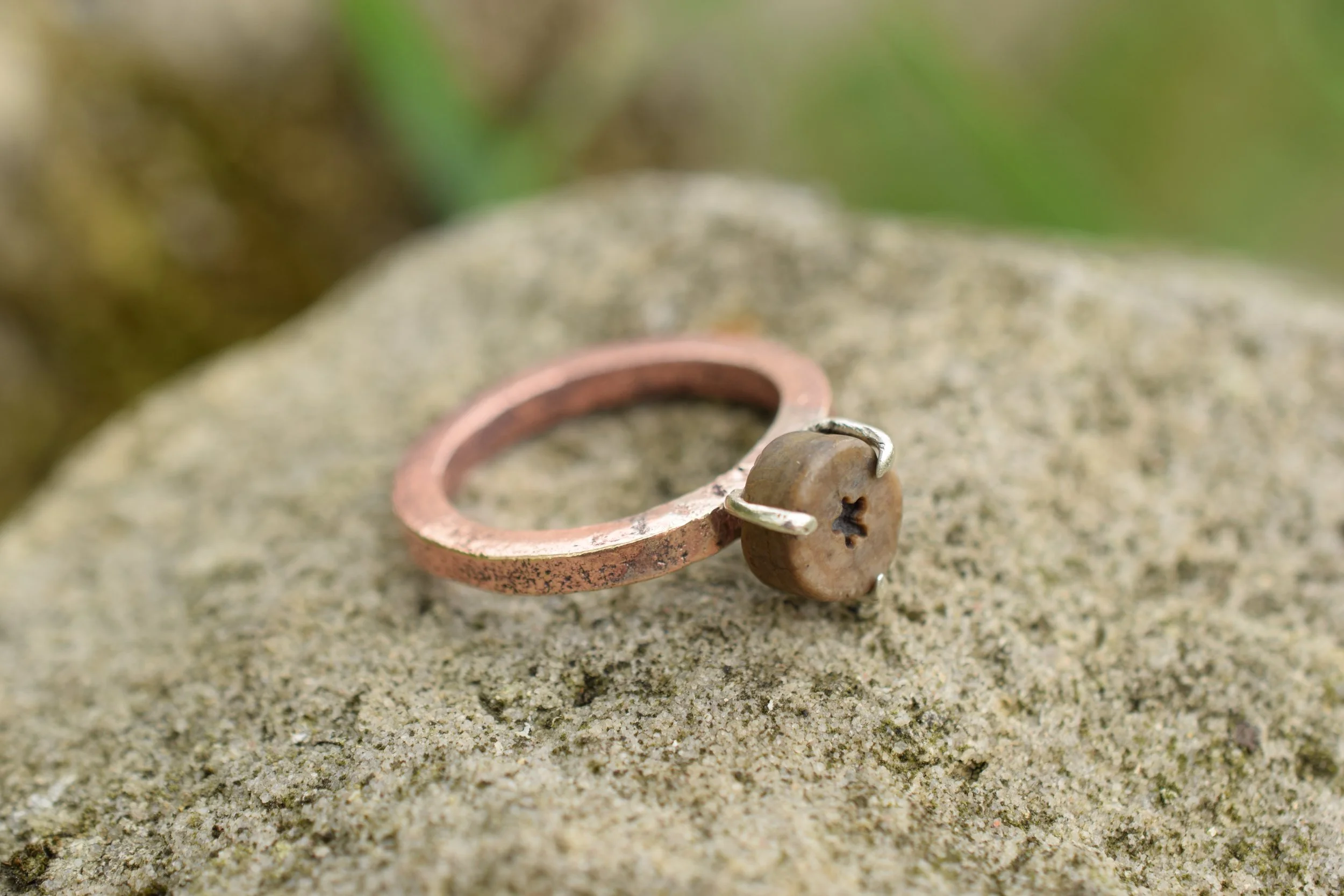 Ring made with found materials from Lindisfarne Island, Northumberland. A copper boat nail and star crinoid fossil or 'St Cuthbert's bead'.