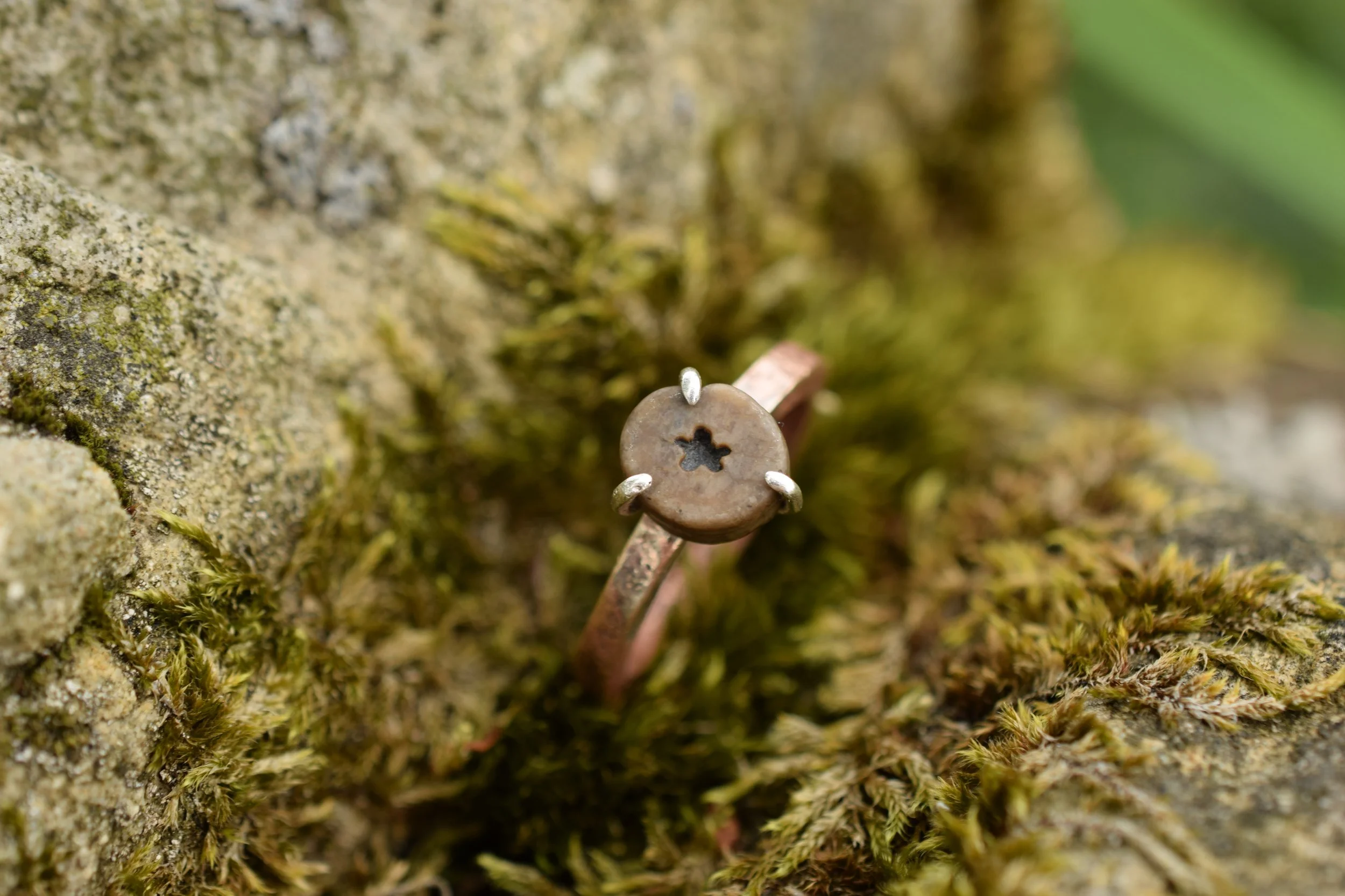 Ring made with found materials from Lindisfarne Island, Northumberland. A copper boat nail and star crinoid fossil or 'St Cuthbert's bead'.