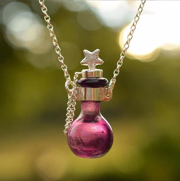 Tiny bottle blown from found victorian glass. Topped with cast crinoid fossil stopper 2022