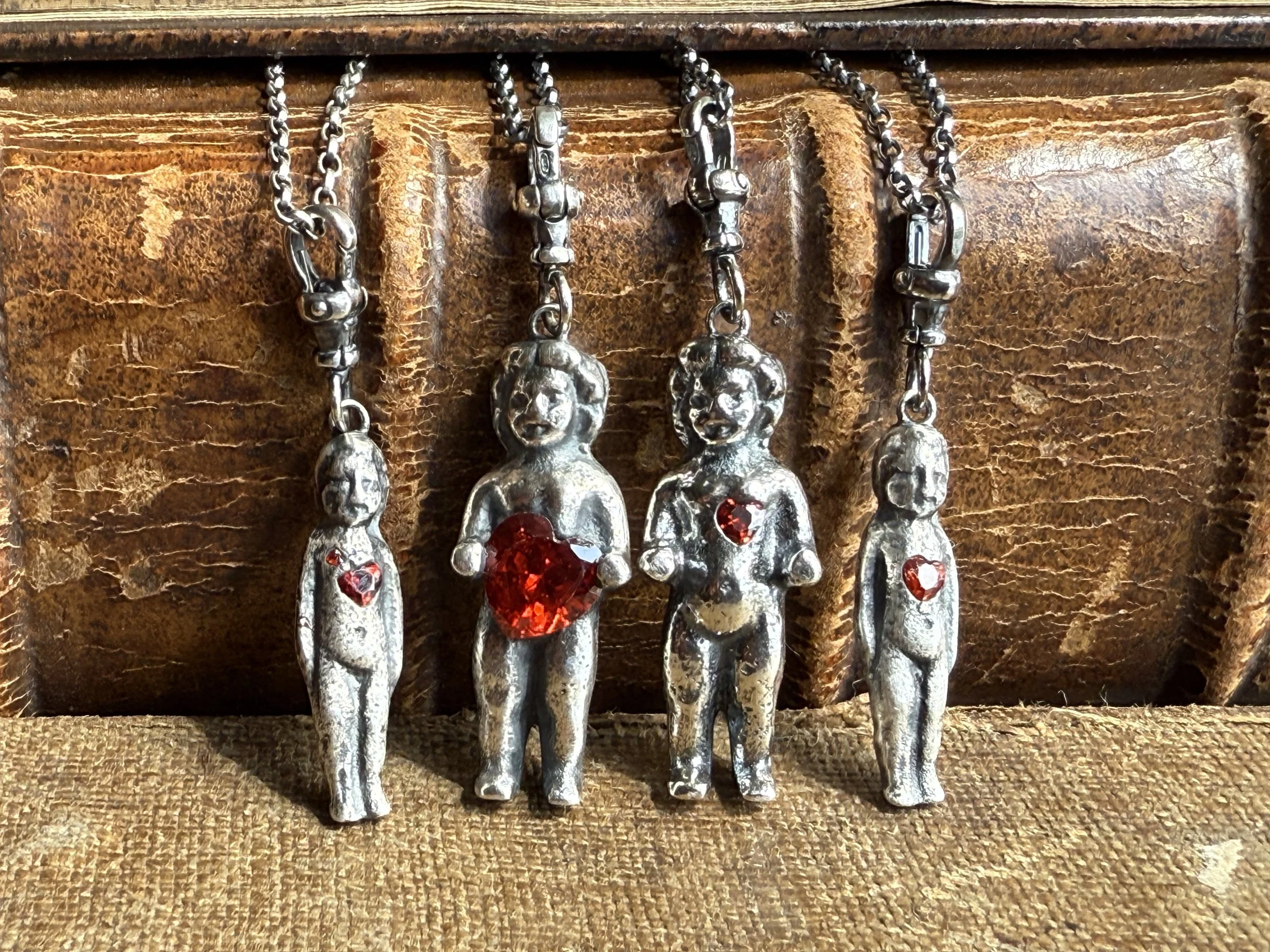 Silver pudding doll/frozen Charlotte dolls cast from our original antique finds, set with crystal hearts. 