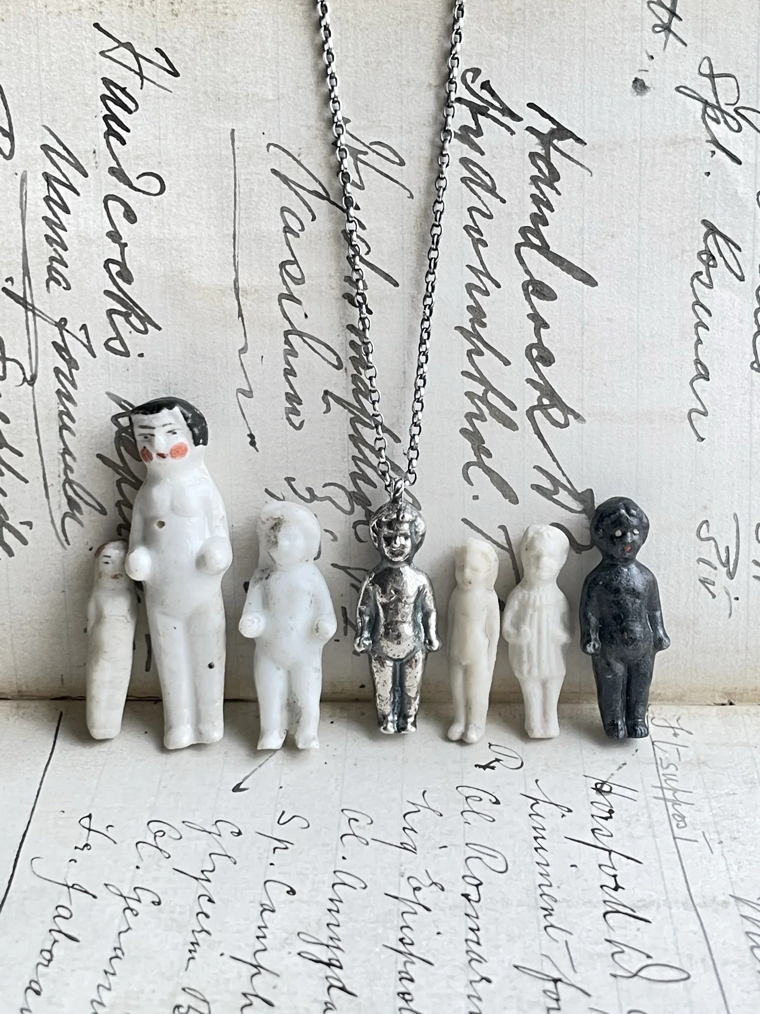 Found antique pudding/penny doll collection with silver dolly necklace.