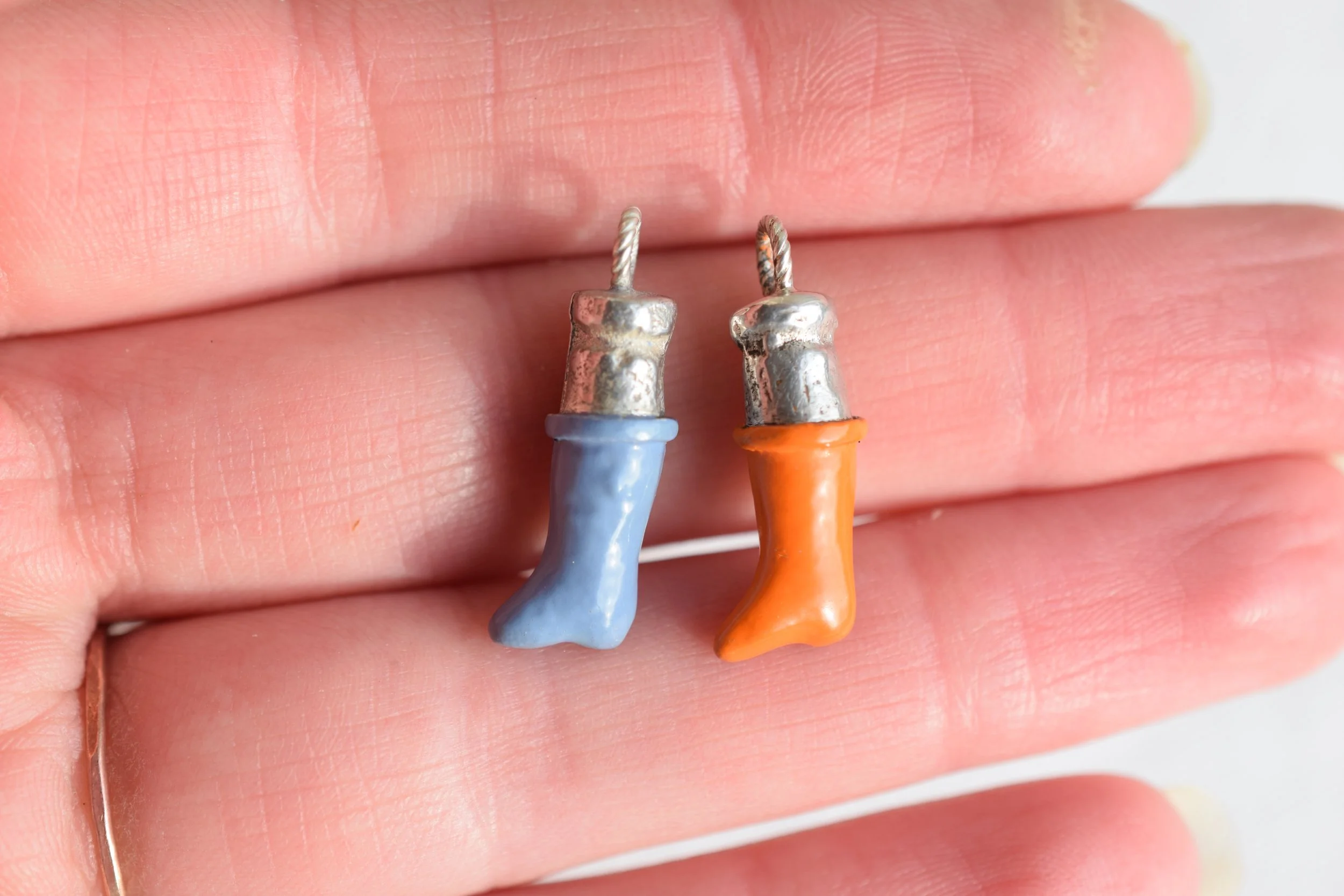Silver & enamel welly boot charms cast from found antique porcelain dolls leg. 