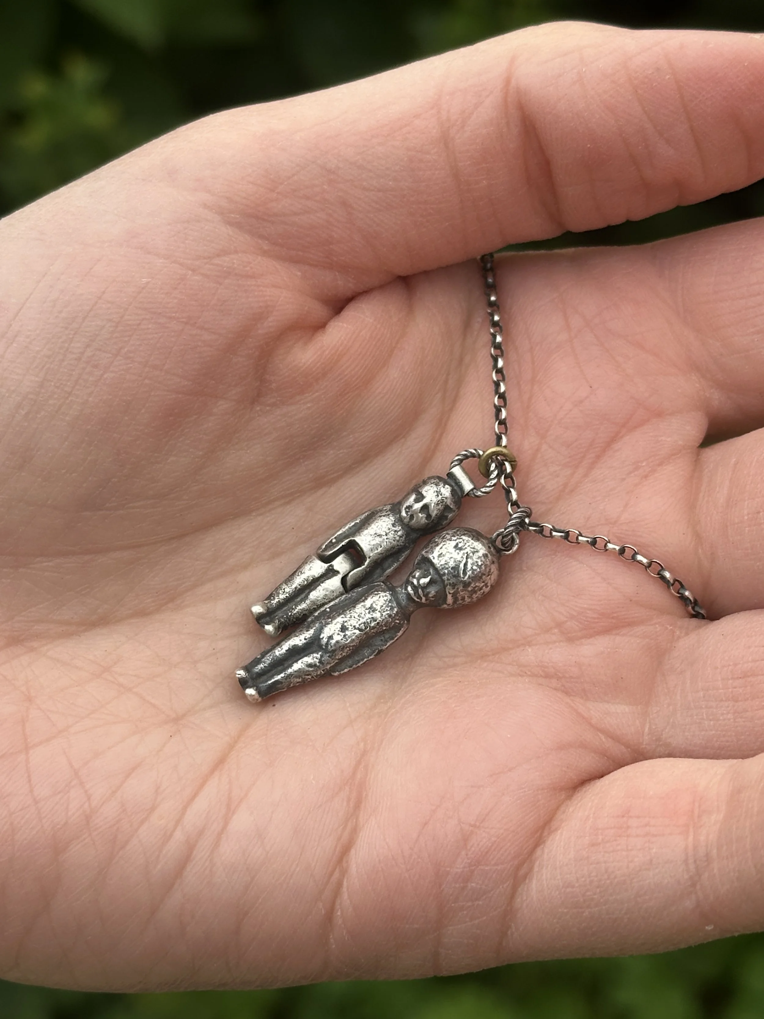 Altered silver pudding doll charms cast from our original finds.