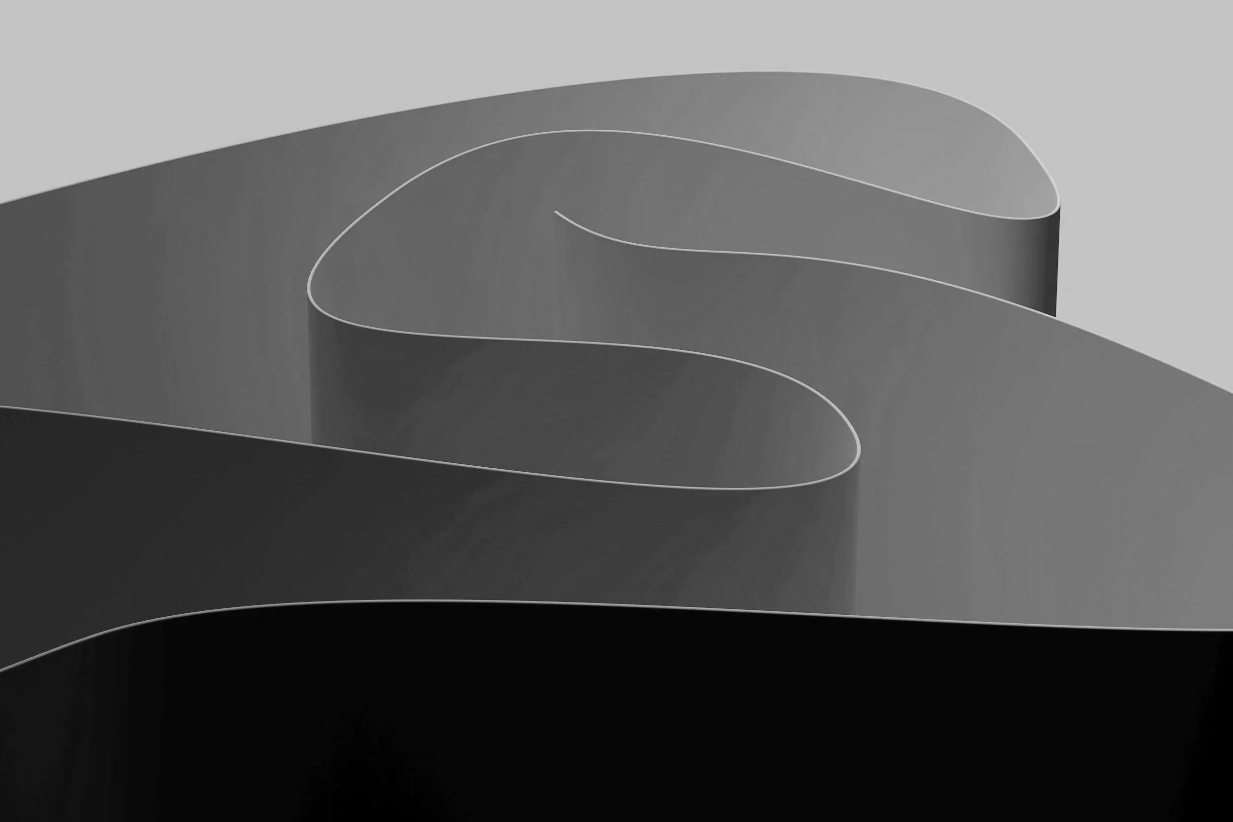 Abstract black and white image of curved, layered shapes resembling a minimalist sculpture or modern art piece.