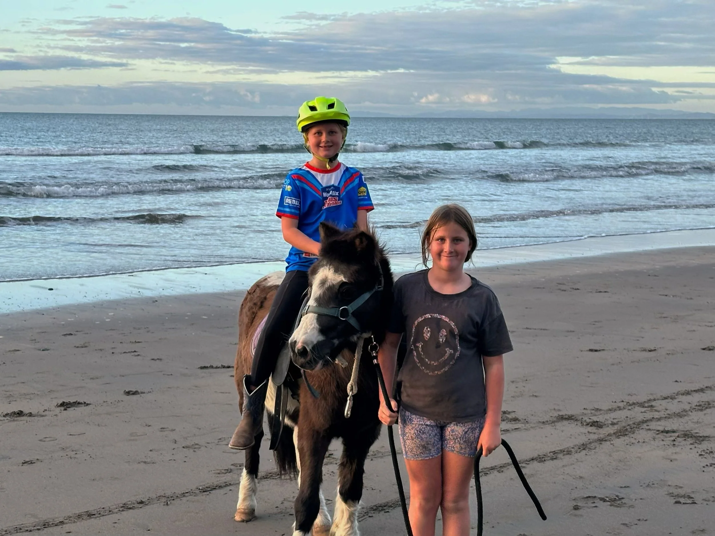 Payne Livestock & Auctioneers | Children riding a horse on the beach in Taranaki.
