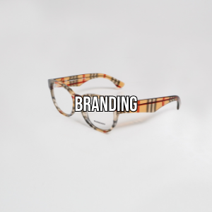 Eyeglasses with a plaid pattern and the word BRANDING over the lenses on a plain white background.