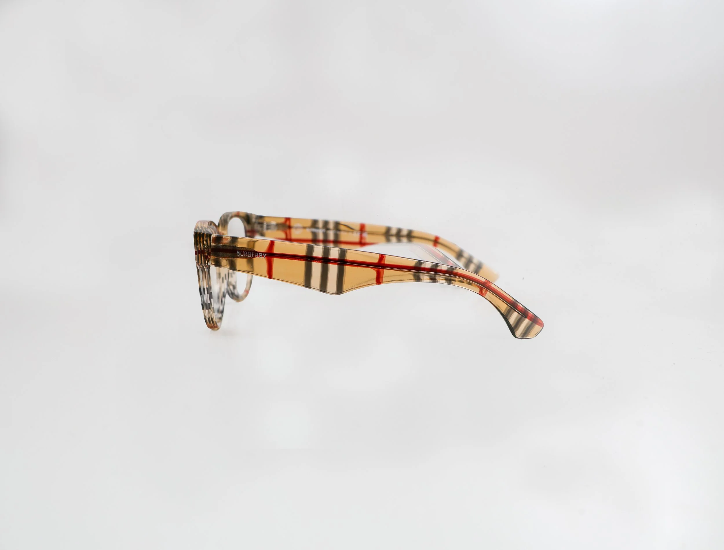 Pair of Burberry eyeglasses with a beige plaid pattern on the frame.