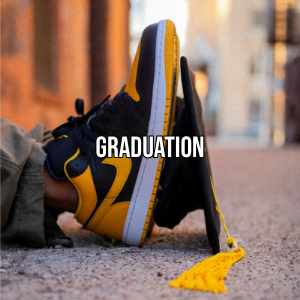 Close-up of a person's foot wearing a yellow and black sneaker with a yellow tassel, resting on the ground with 'GRADUATION' text overlayed.