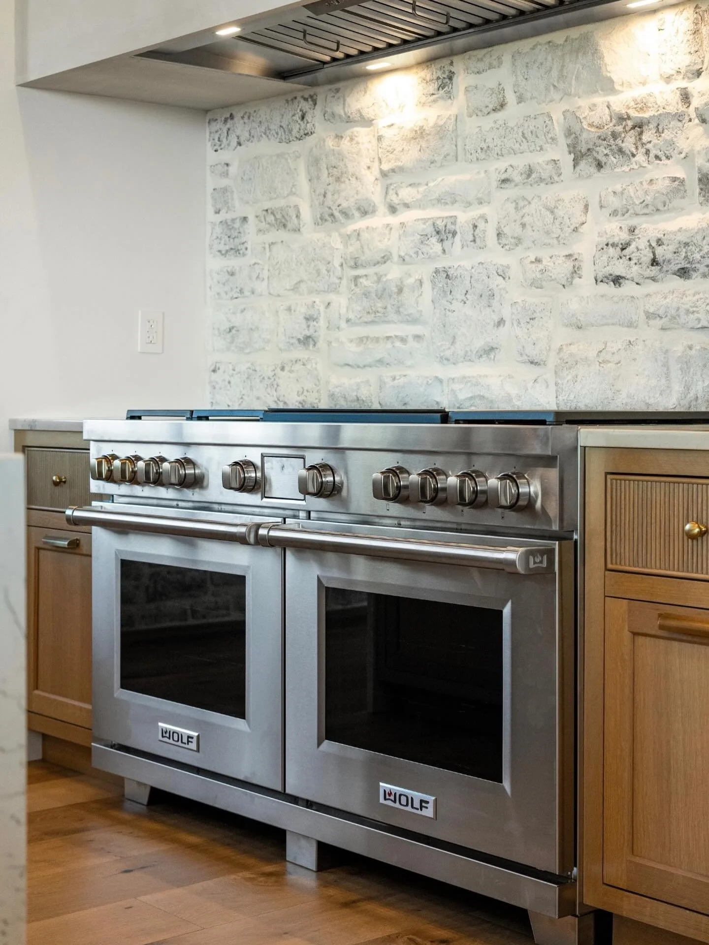 Range room for days.  This @subzeroandwolf unit anchors the kitchen, with the same stone on the backsplash as is used on the exterior.