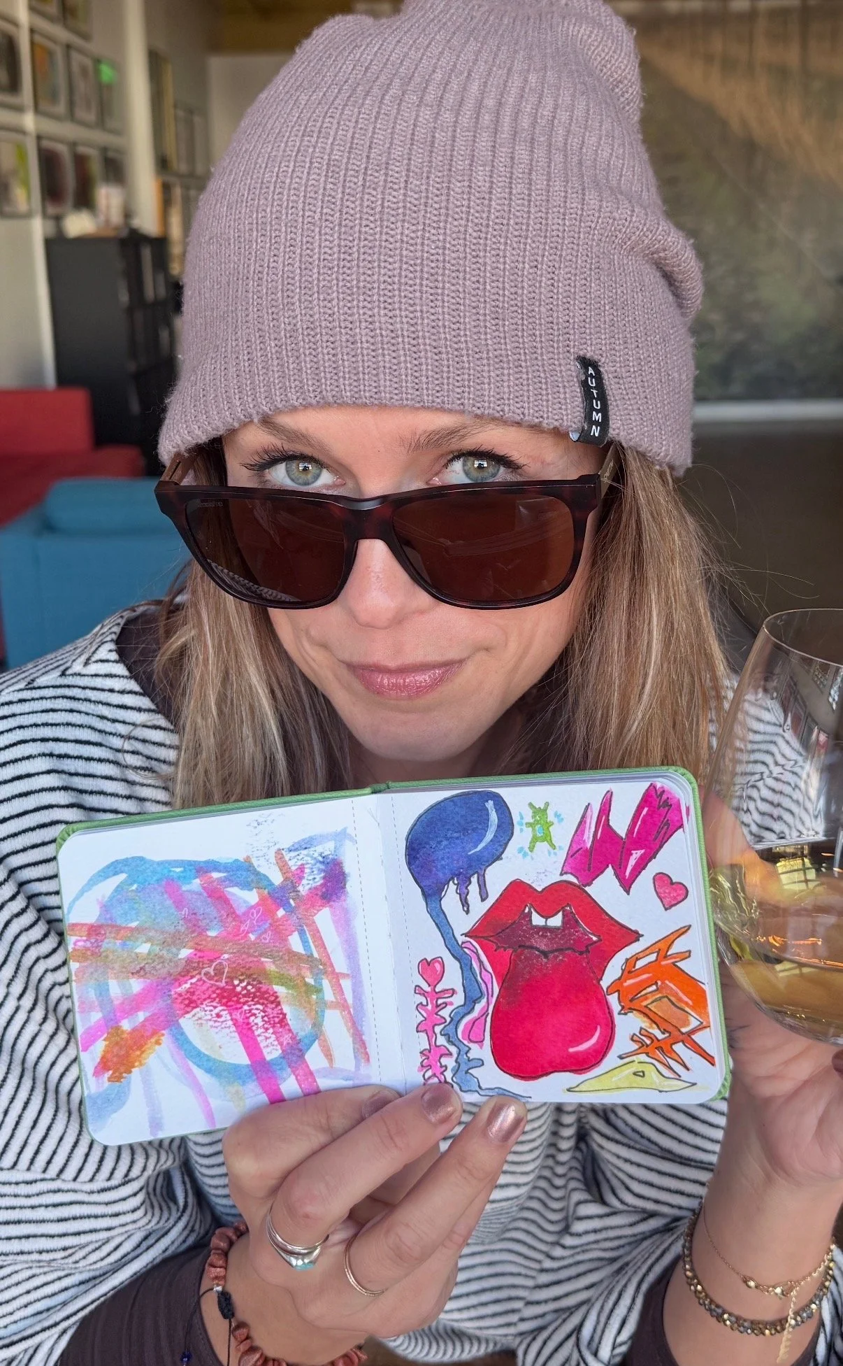 Brittani Dinsmore and her watercolor journal with a glass of wine at Sleight of Hand in Seattle.