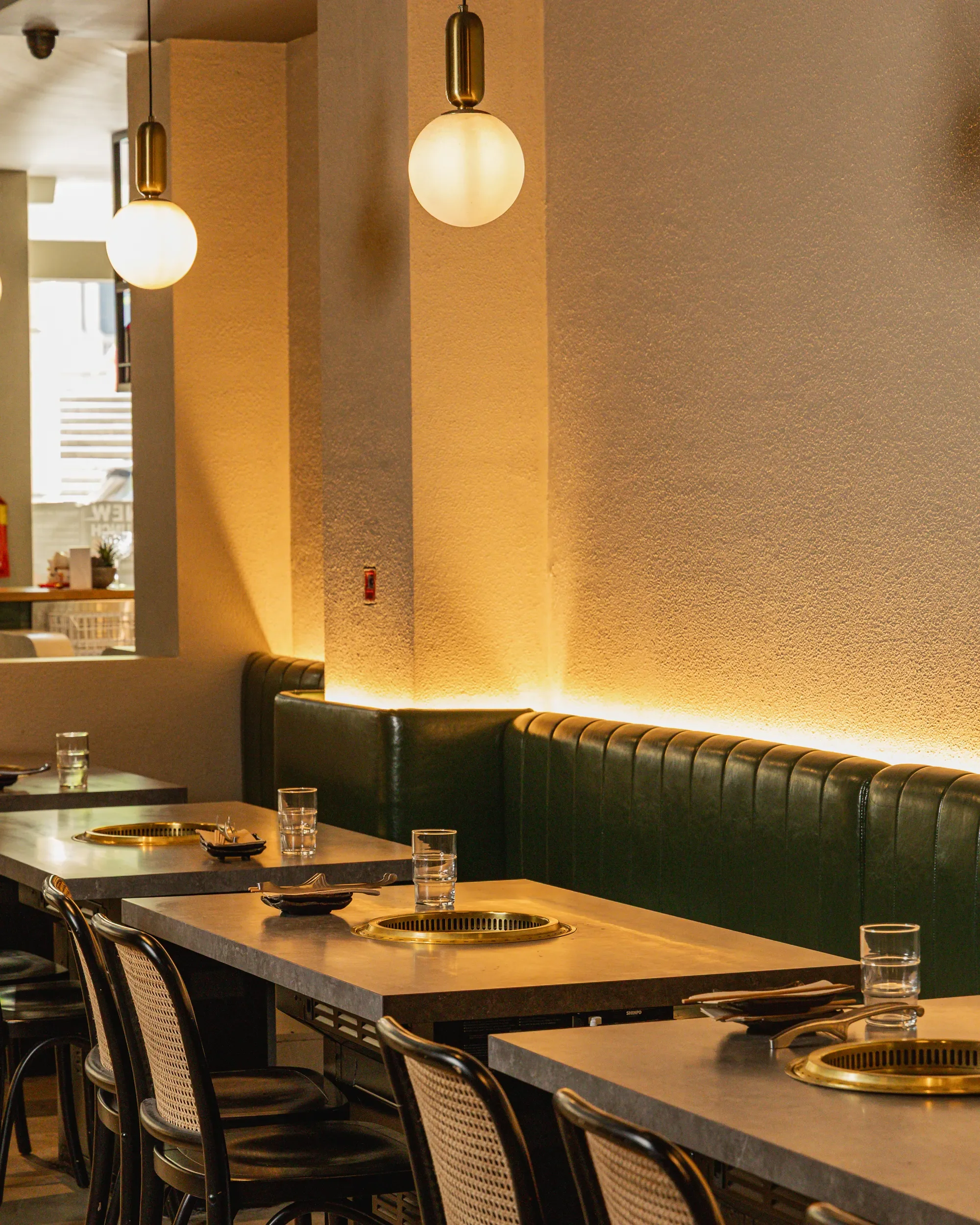 photo of tajima restaurant group dining space with  tables and grills