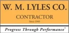 Business sign for W. M. Lyles Co., a contractor, established in 1945, with the slogan 'Progress Through Performance'.