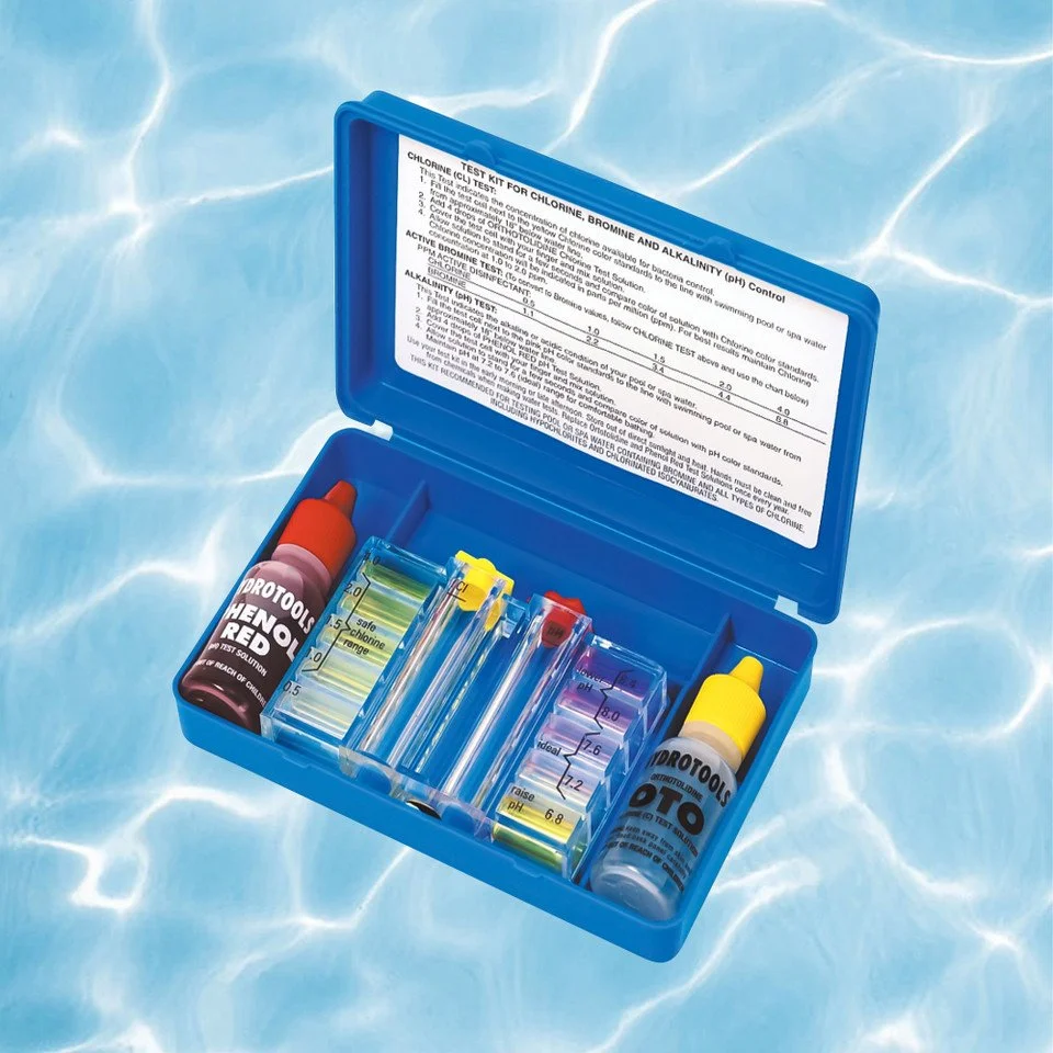 A blue plastic case containing water testing kit bottles and strips situated on water with light reflections.