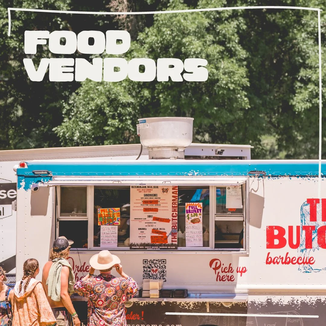 Food truck serving barbecue with a line of people waiting to order, green trees in the background.