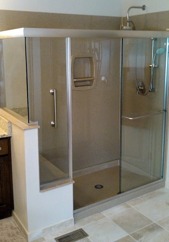 Tub to shower conversion with sliding glass doors and built-in shower shelving