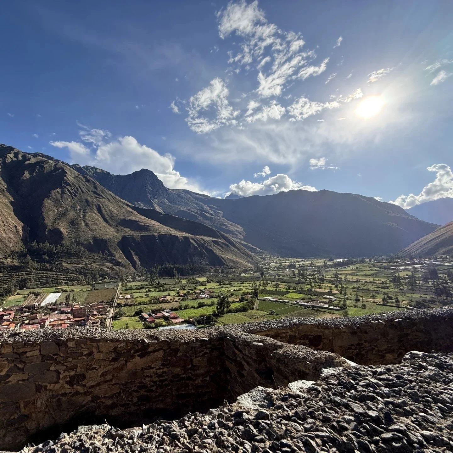 View over the Sacred Valley from the Ollantaytambo ruins with mountains and farmland below