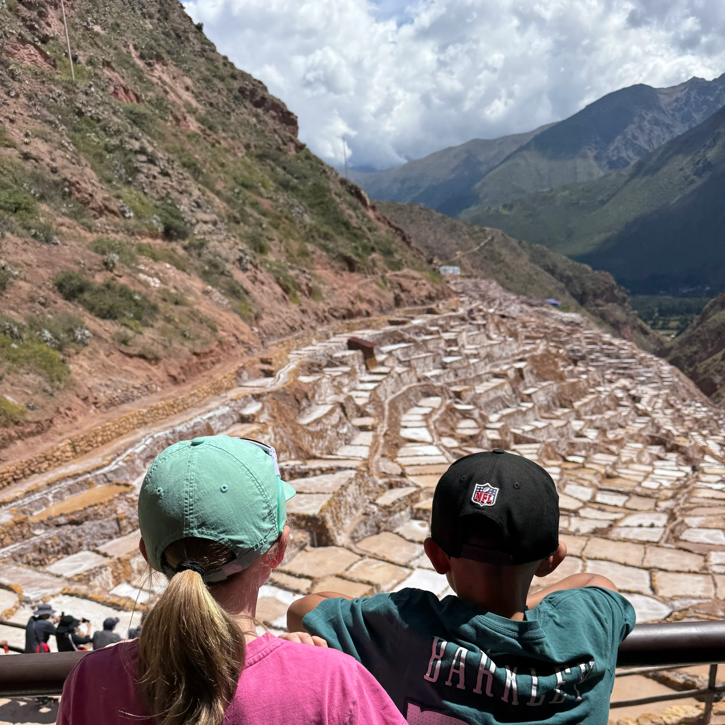 Boy and girl overlooking the Maras salt ponds in Peru’s Sacred Valley