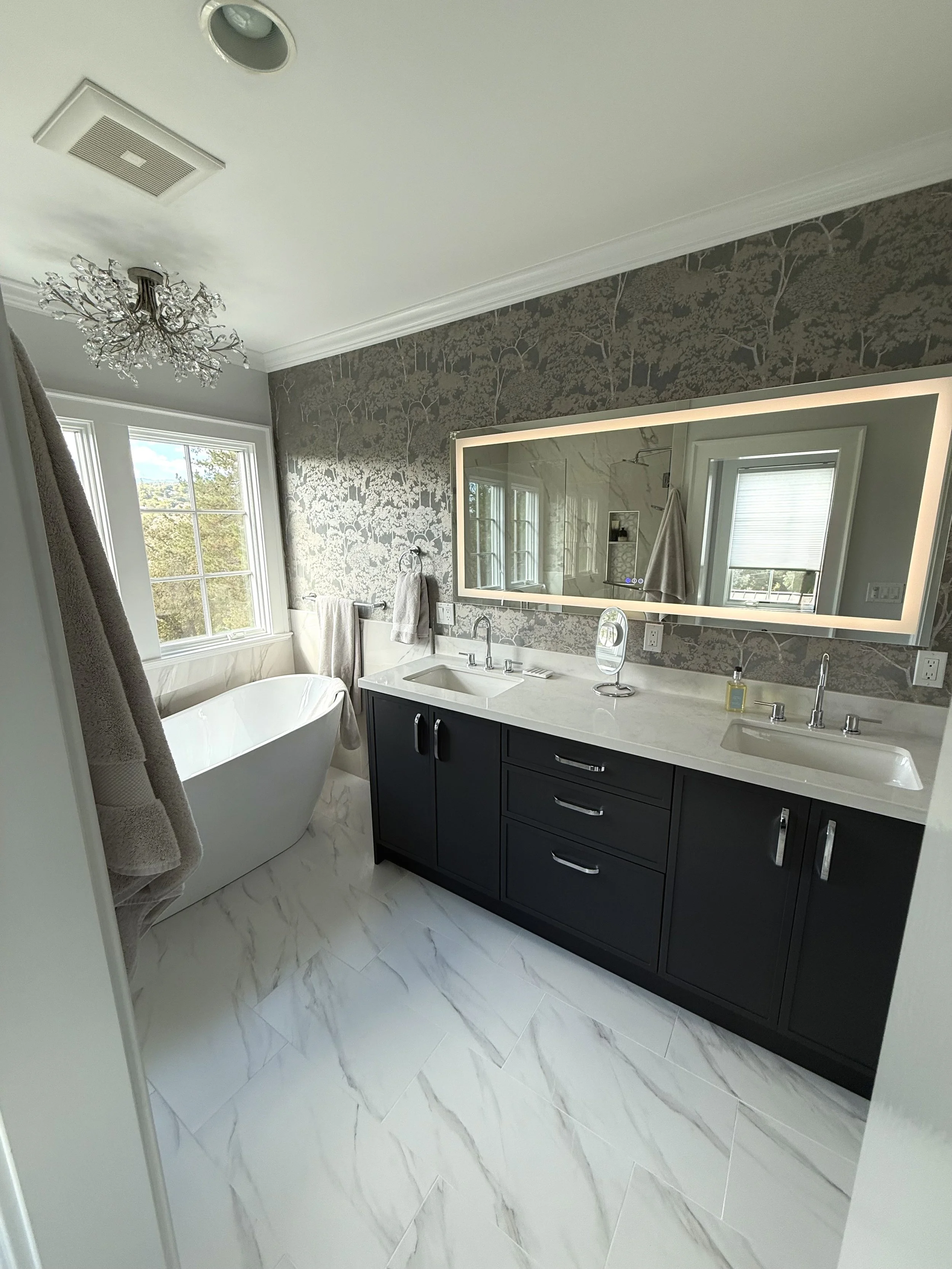 Full master bathroom remodel with custom wallpaper and freestanding tub