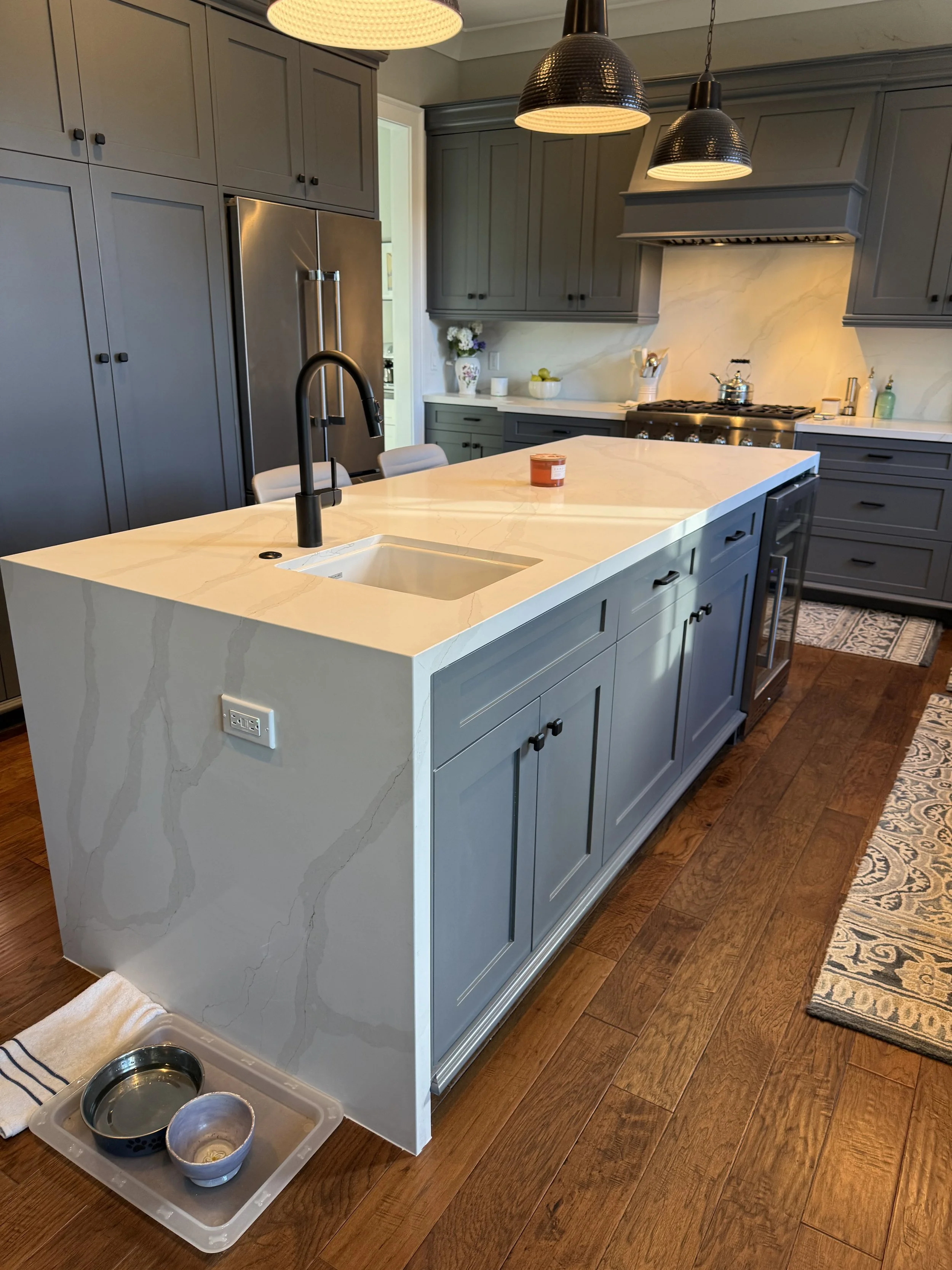 Custom stone fabrication and installation with waterfall edge detail 