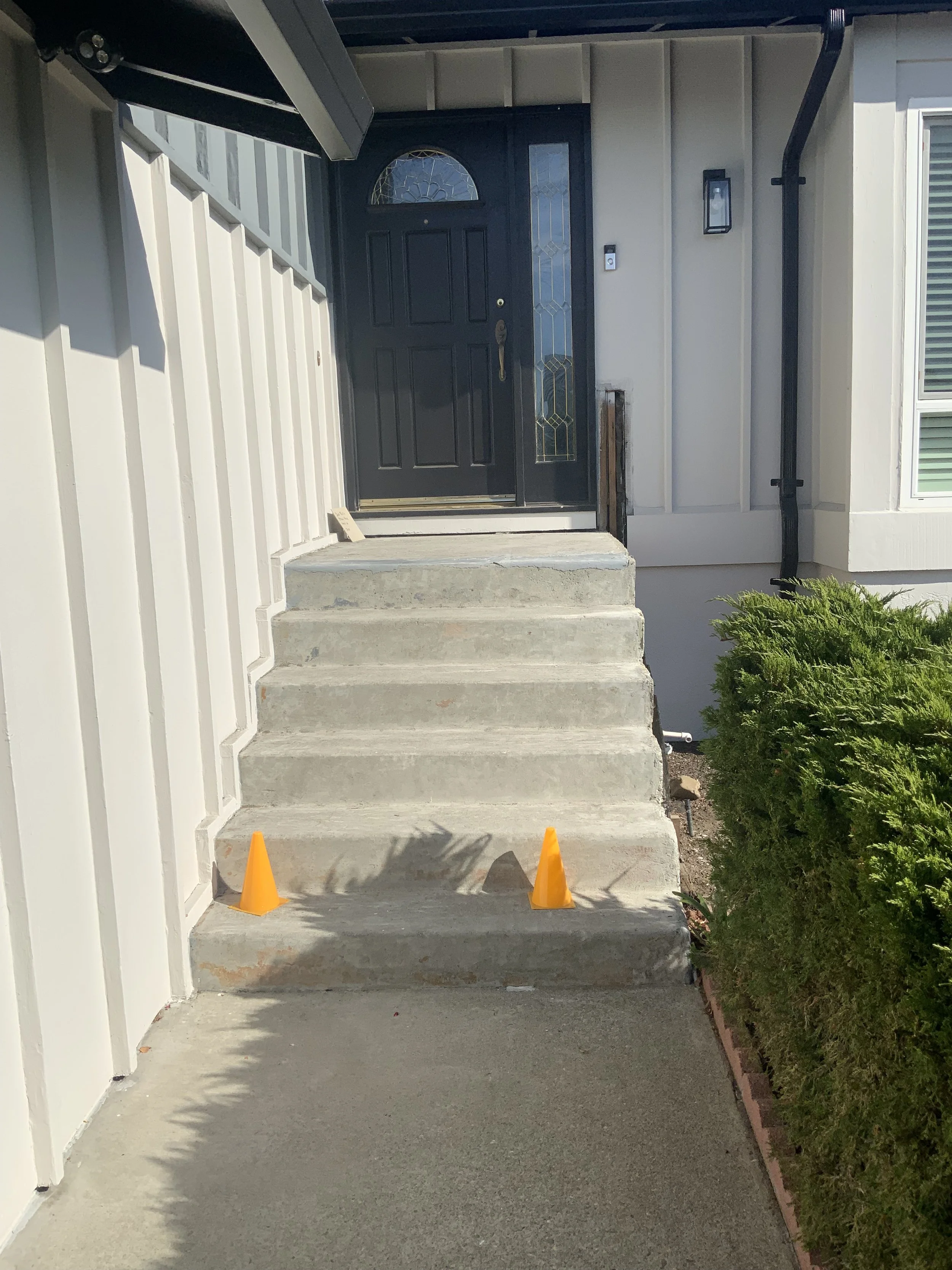 Before: Unsafe concrete steps with deteriorating structural support