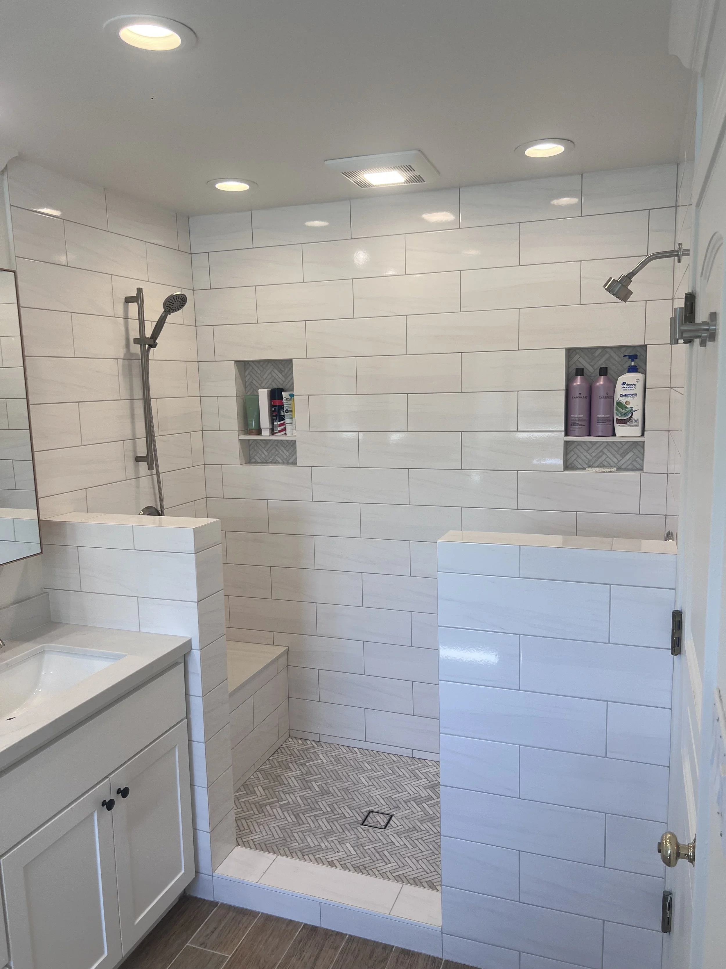 After: Updated shower with new tile, recessed niches, and upgraded fixtures