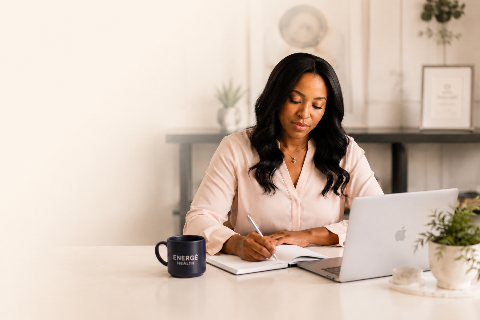 A woman at her desk during a telehealth appointment with Energē Health