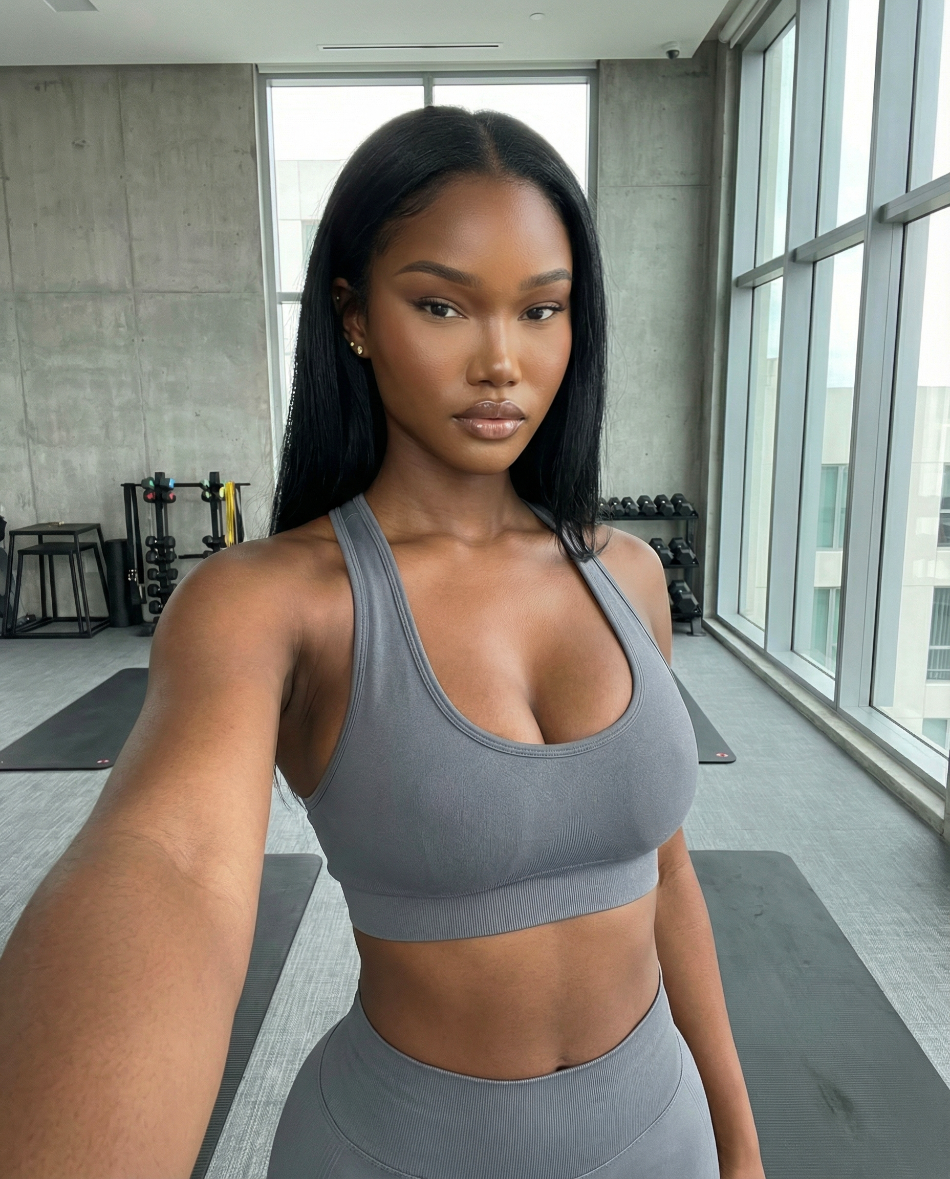 AI-generated realistic influencer avatar wearing gray workout clothing in a gym setting, created using a copy-paste AI avatar prompt.