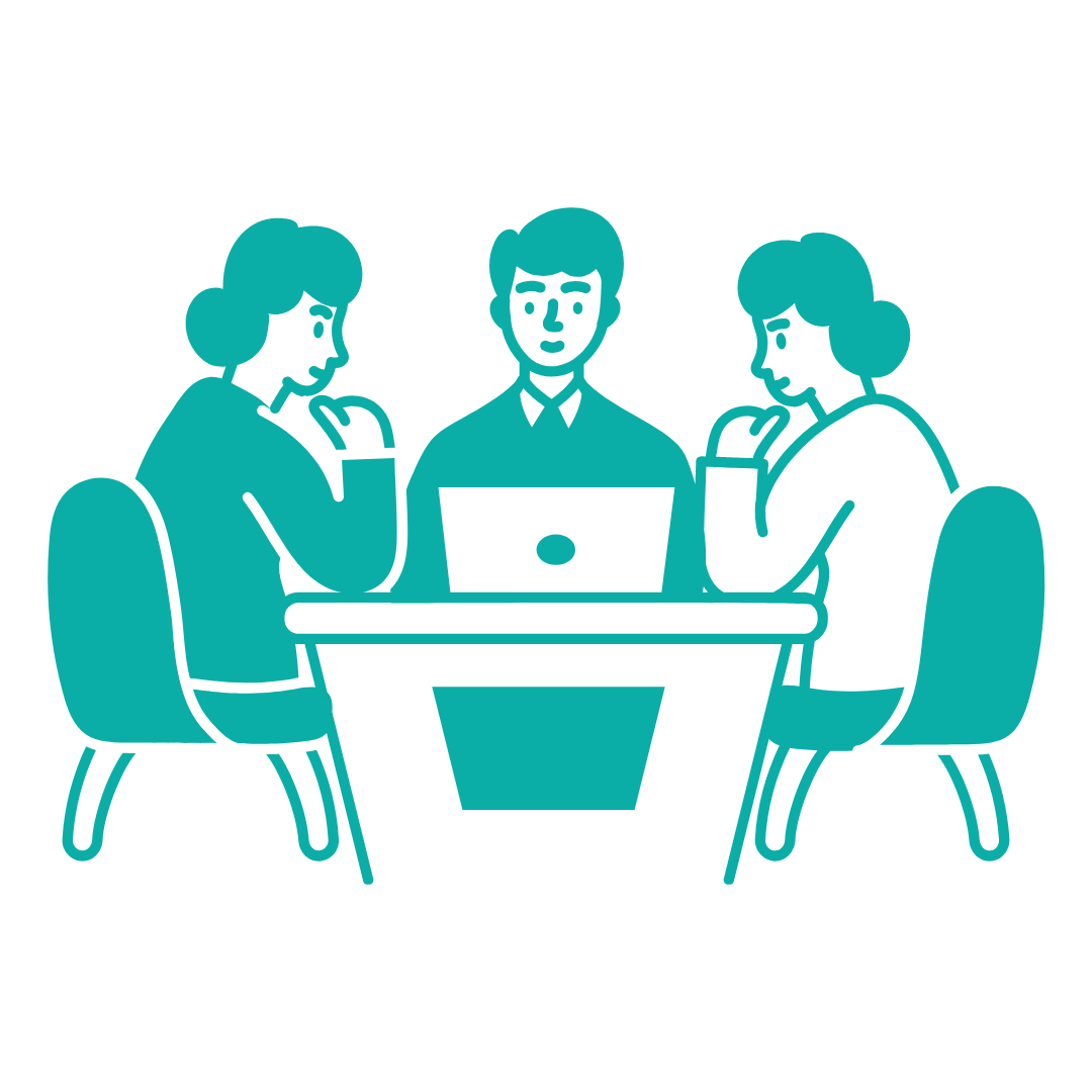 Three people sitting around a table with a laptop, engaged in discussion.