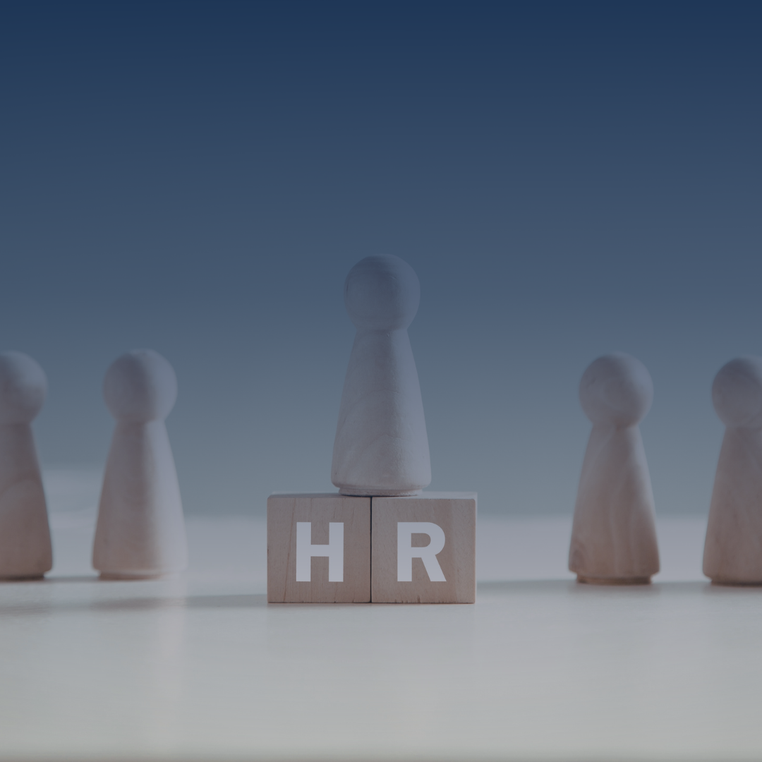 Wooden game pieces with the letters 'H' and 'R' on blocks in front, surrounded by other similar pieces, set against a blurry background.