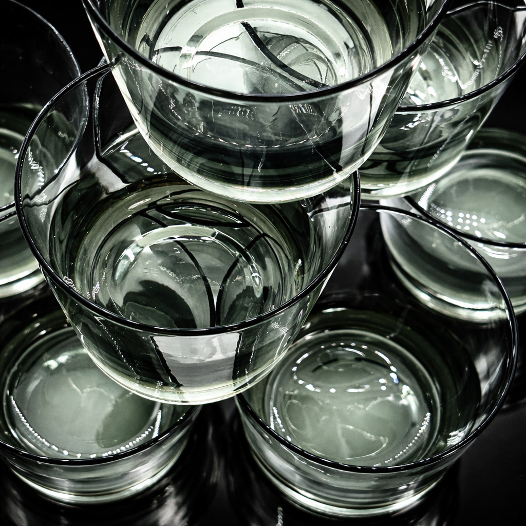 Stacked clear glass cups viewed from above, reflecting light.