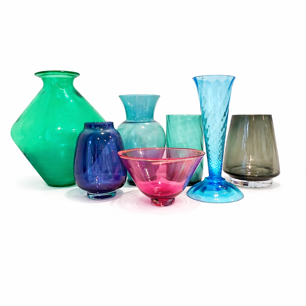 A collection of colorful glass vases and bowls against a white background.