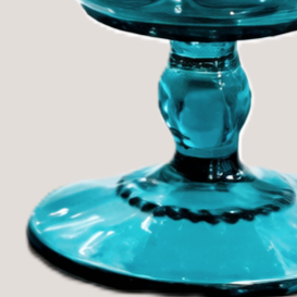 Close-up of a blue glass pedestal or goblet.