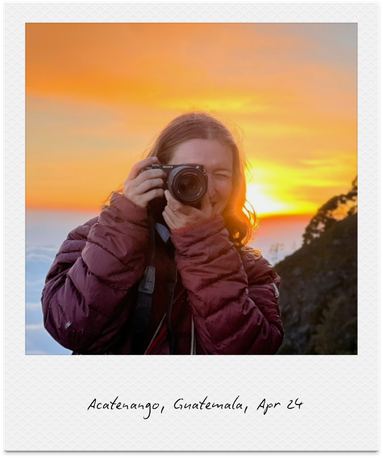 A woman with a camera taking a photo during sunset at Acatenango, Guatemala.