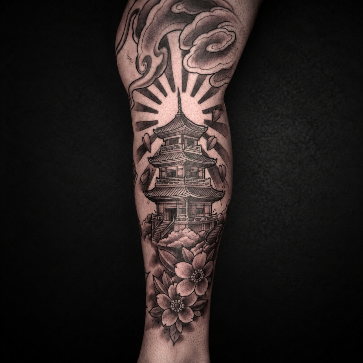 Black and grey ornamental forearm tattoo with symmetrical details by Adrian Aguirre.