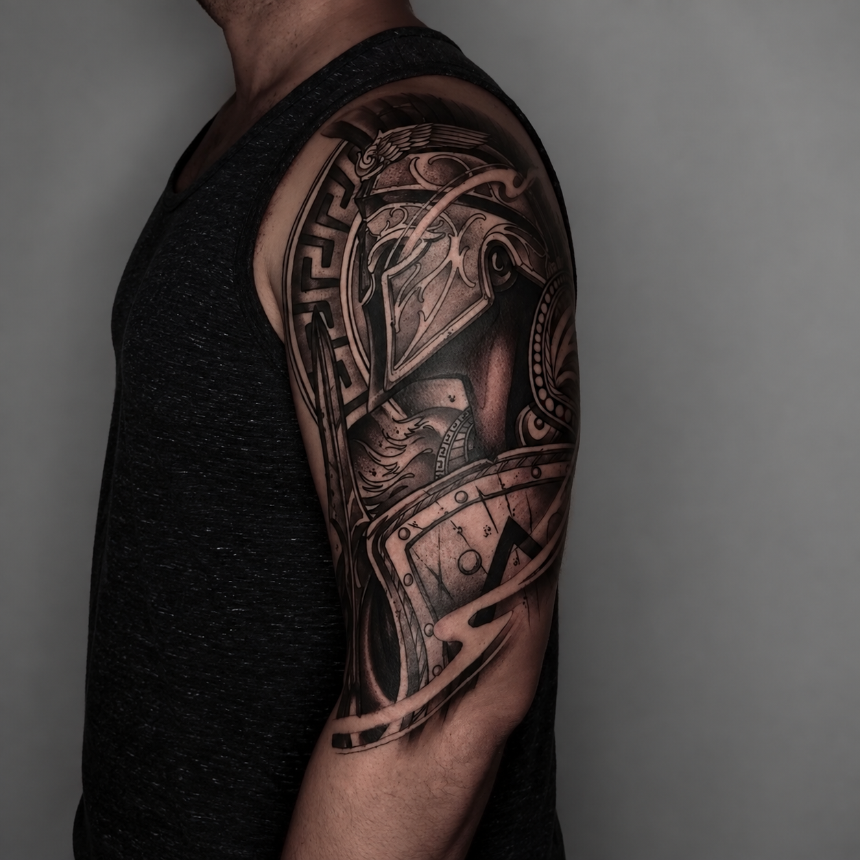 Black and grey ornamental sleeve tattoo by Adrian Aguirre.