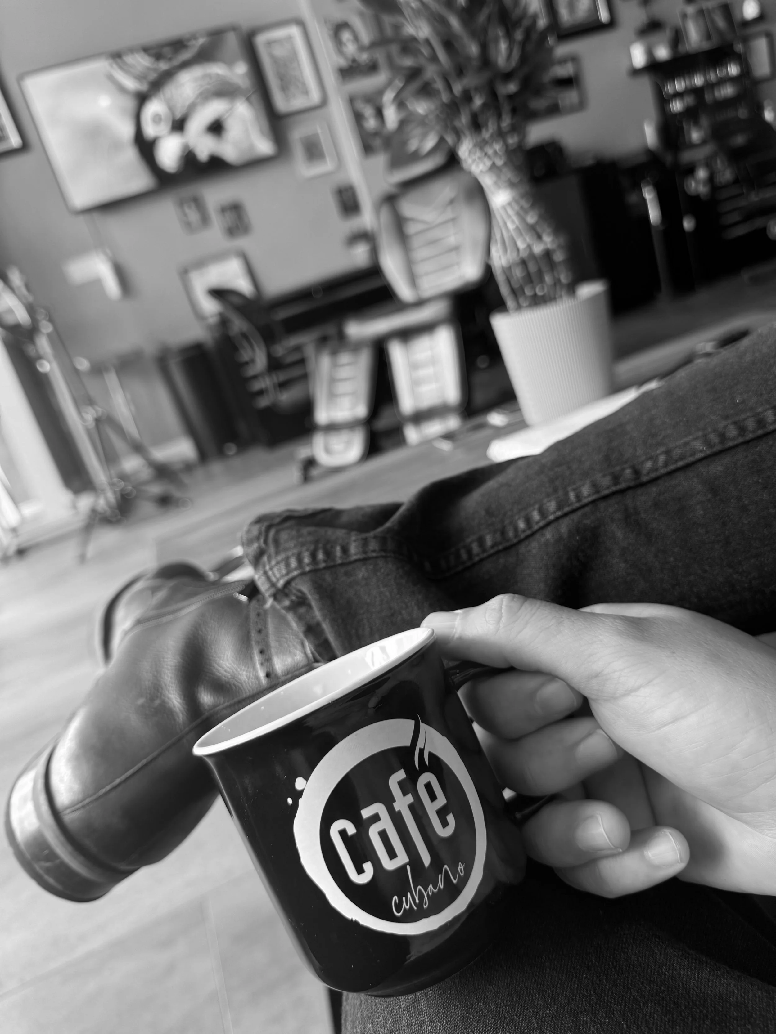 Relaxed atmosphere inside a professional tattoo studio during a color cover up tattoo consultation.