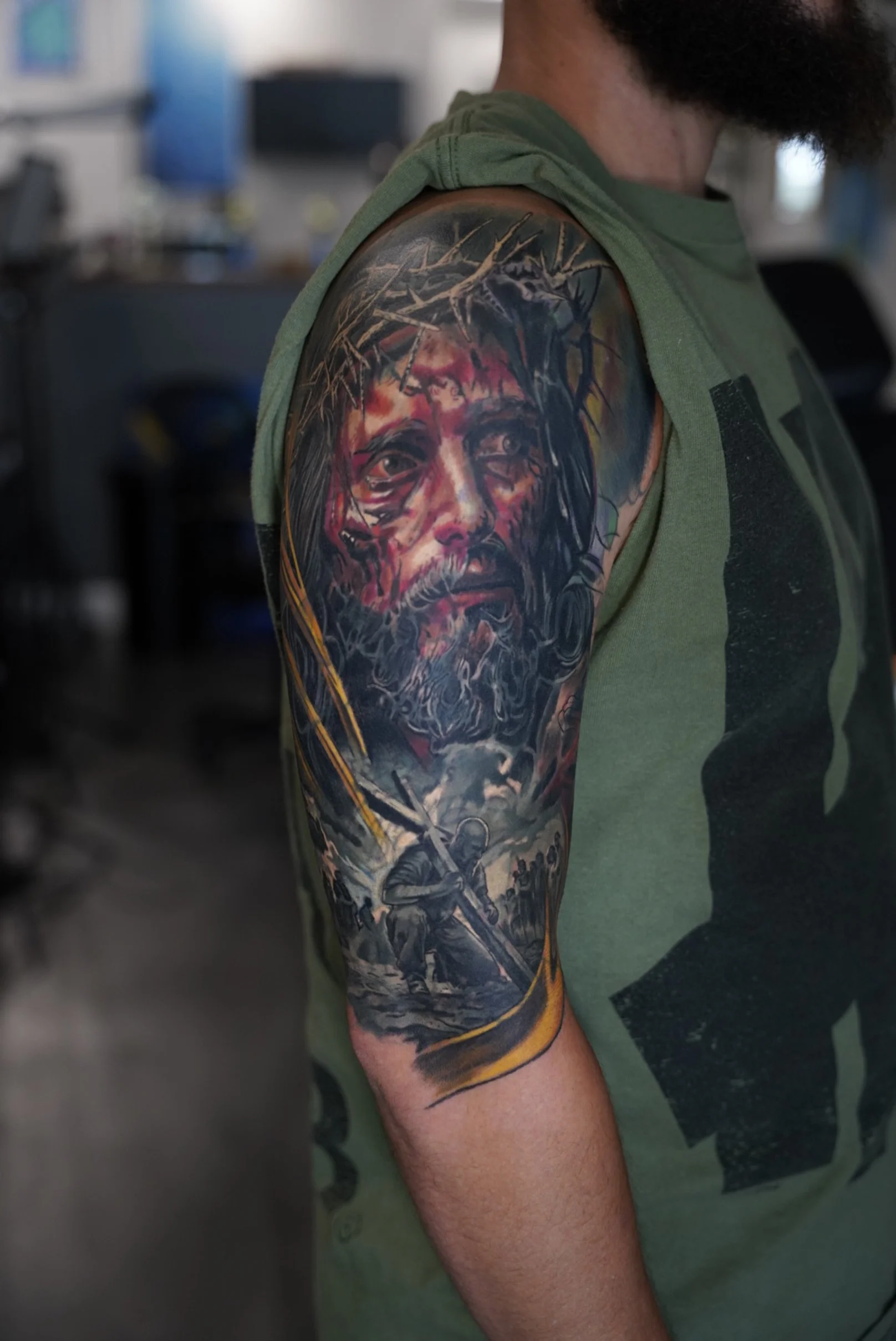 Healed black and grey realism tattoo featuring a detailed portrait of Jesus Christ, combined with a symbolic scene below, creating depth, emotion, and contrast throughout the composition.